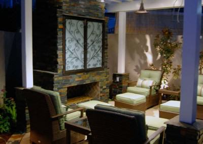 Outdoor living room with fireplace and Pergola featuring outdoor television cabinet