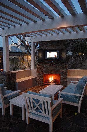 Outdoor living room with fireplace and flat screen tv