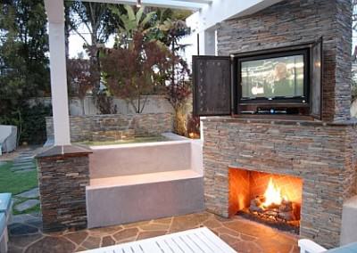 Outdoor living room with fireplace and flat screen tv